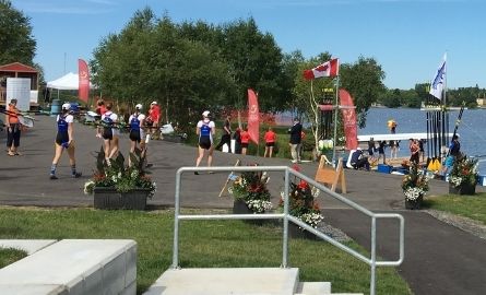 rowers at rowing club dock getting ready to compete